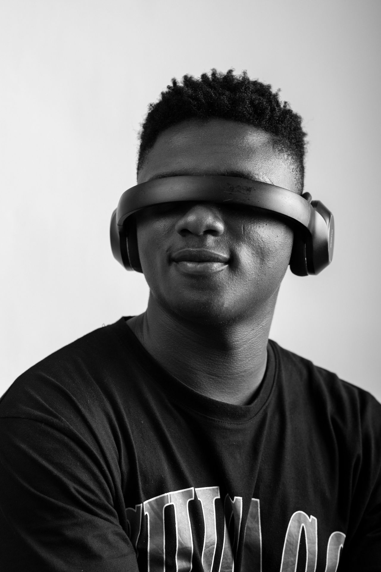 a man wearing a pair of headphones while wearing a t - shirt